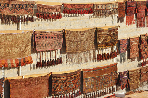 wall showcase with old traditional carpets