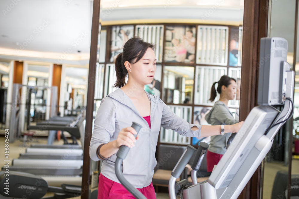Asian woman running with machine walking Asian woman running with machine walking