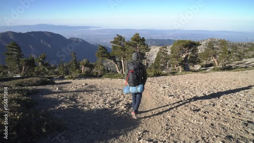 Backpacker alone hiking in the mountains