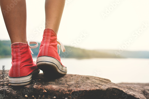 Feet of young girl in the park on nature, Relax time on holiday