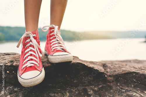 Fotografi Feet of young girl  in the park on nature, Relax time on holiday