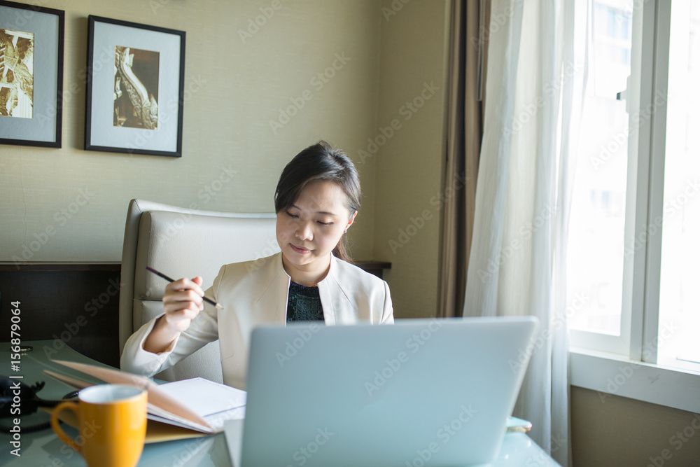 Asian business woman calling in the office room. Asian business woman calling in the office room.