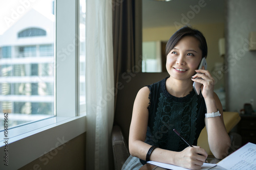 Asian business woman calling in the office room.