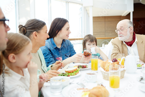Big family having breakfast or dinner © pressmaster
