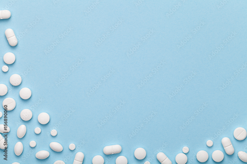 White Medical Pills on Blue Background