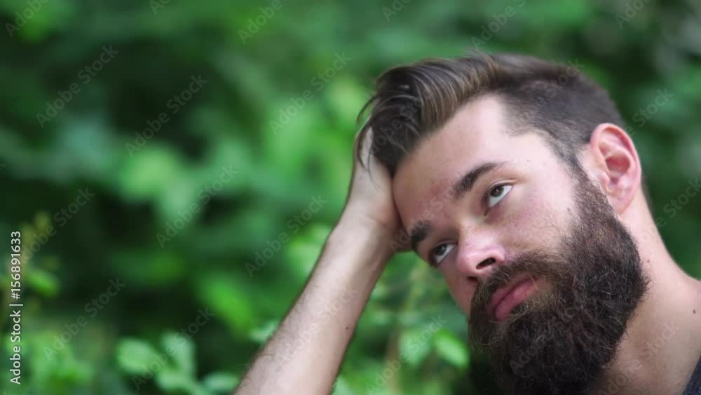 Young hipster guy with beard touching his hair Young hipster guy with beard touching his hair