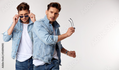 Closeup portrait of a young stylish guy wearing a jeans' jacket photo