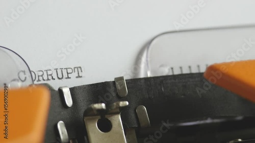 Close up footage of a person writing CORRUPTION on an old typewriter, with sound...