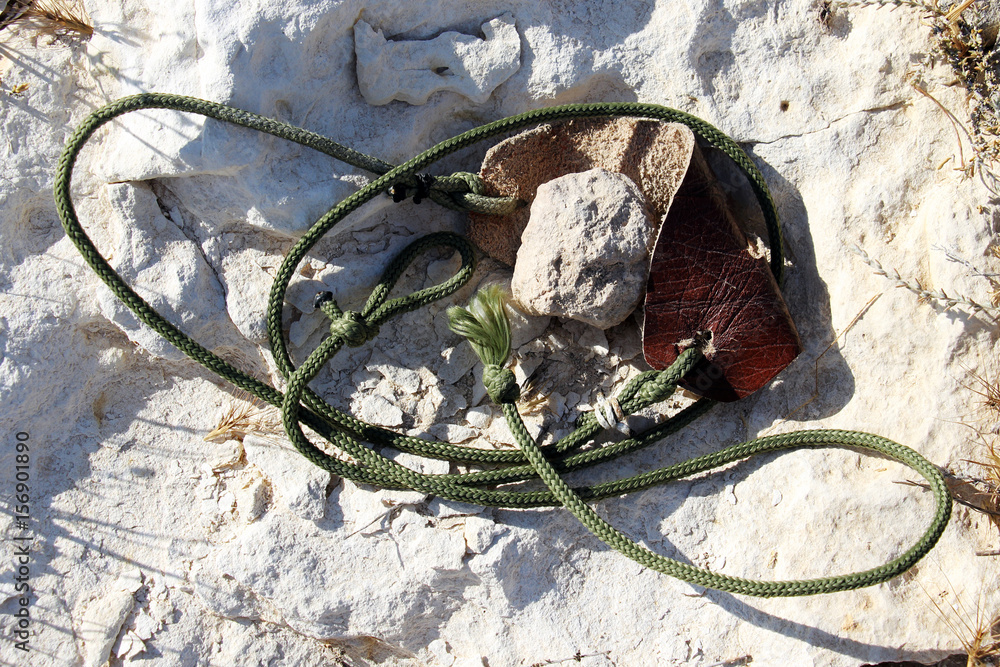 Ancient weapon - Sling for stone throwing. Photos