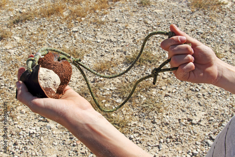 Ancient weapon - Sling for stone throwing. Photos