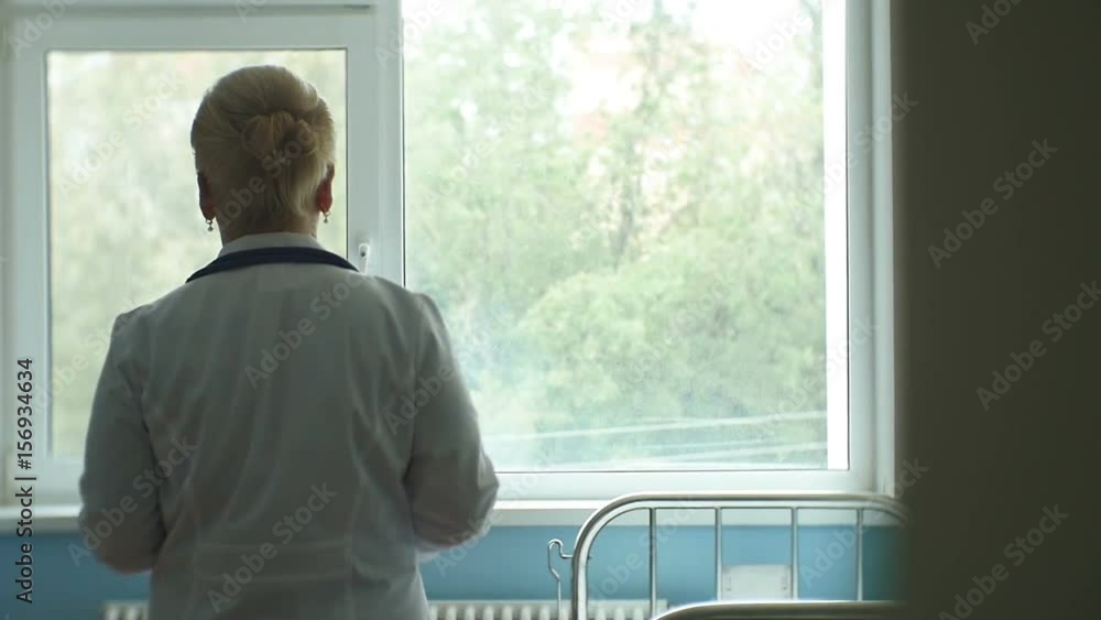 Slow Motion Backside View Nurse Walks across Ward Slow Motion Backside View Nurse Walks across Ward