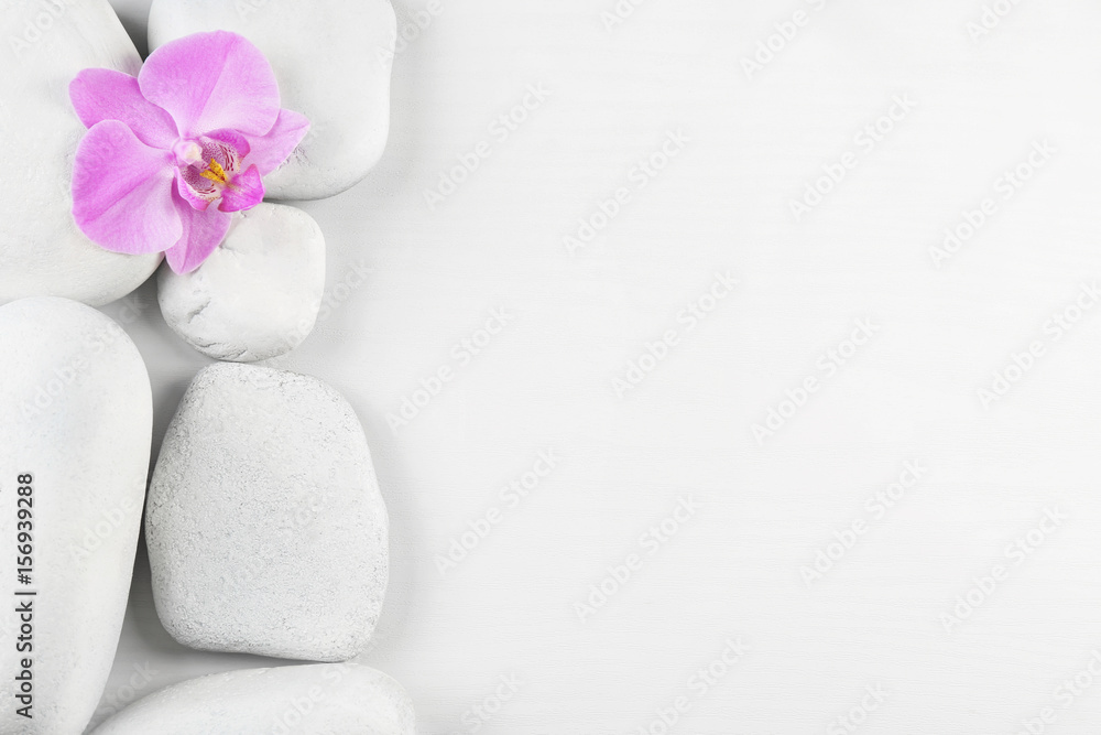 Spa stones with orchid flower on white background Spa stones with orchid flower on white background