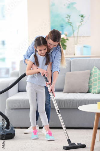 Mother and daughter cleanin...