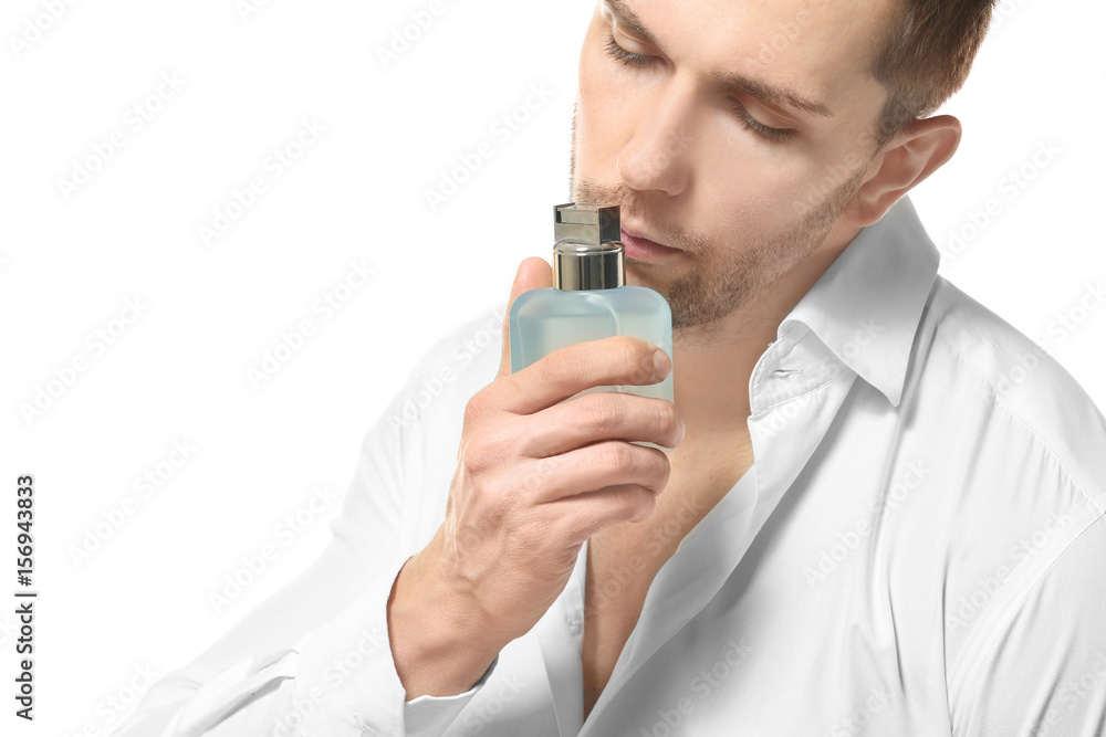 Handsome man using perfume on white background Handsome man using perfume on white background