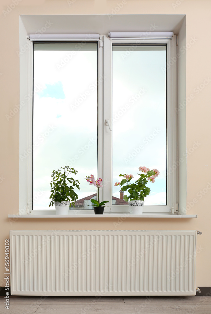 Fototapeta premium Big window with plants on sill at home