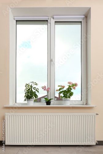 Big window with plants on sill at home