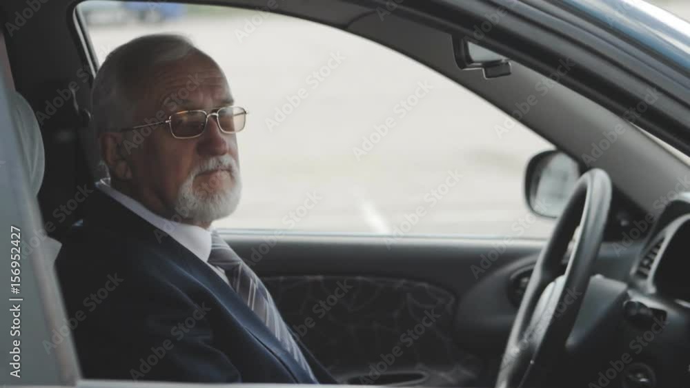 Senior man into the car. Businessman sitting in auto. Senior man into the car. Businessman sitting in auto.