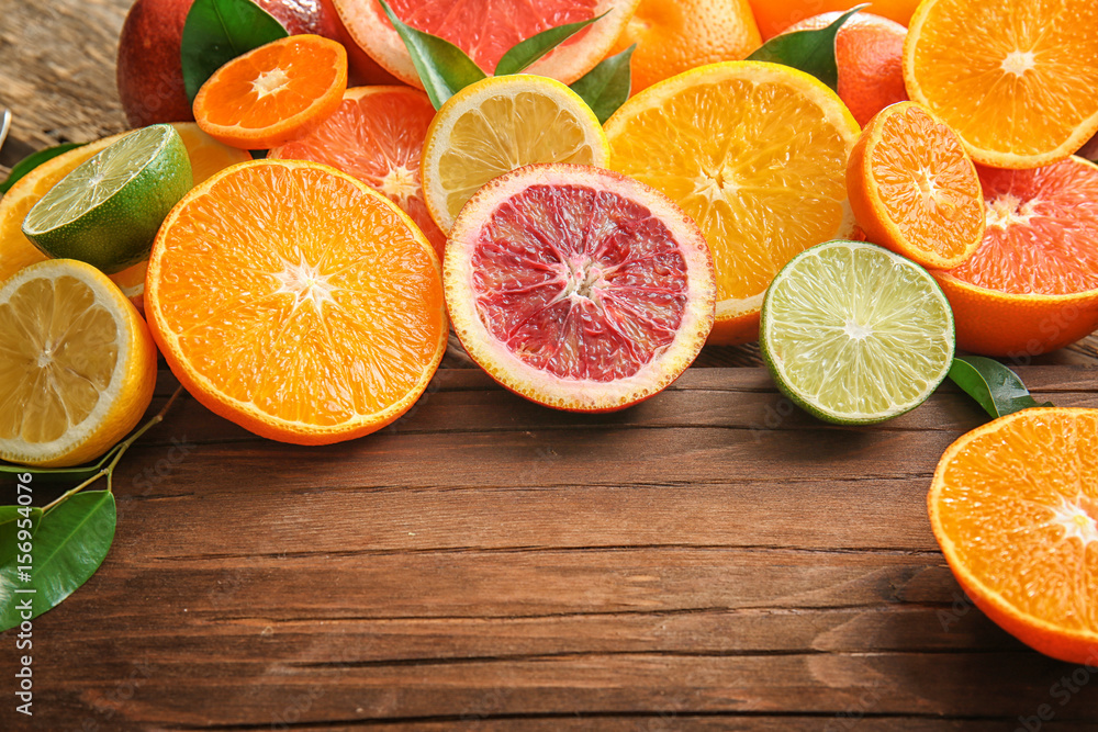 Beautiful composition with citrus fruits on wooden background Beautiful composition with citrus fruits on wooden background