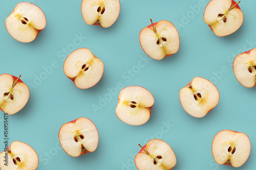 Apple slices pattern on a blue background. Repetition concept. Top view. Flat lay