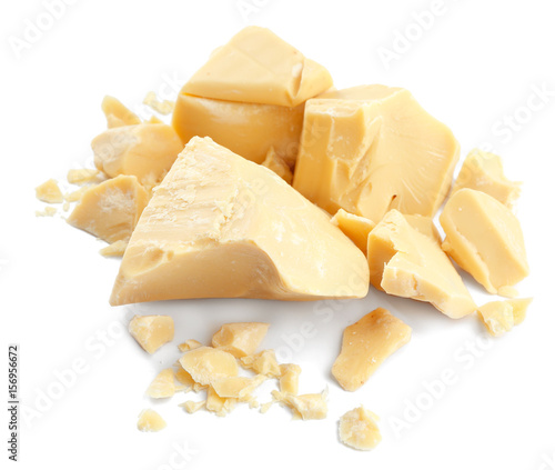 Pieces of cocoa butter on white background