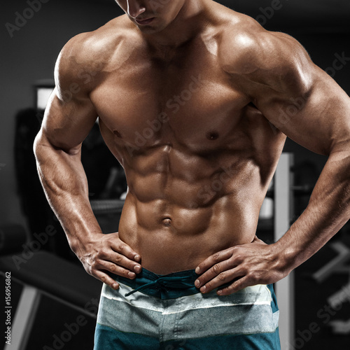 Obraz na plátně Muscular man abs in gym, shaped abdominal