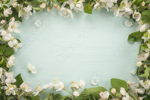 Spring flowers frame on wooden background 
