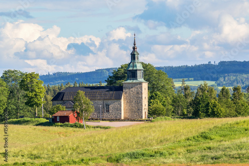 Swedish rural church in summer landscape photo