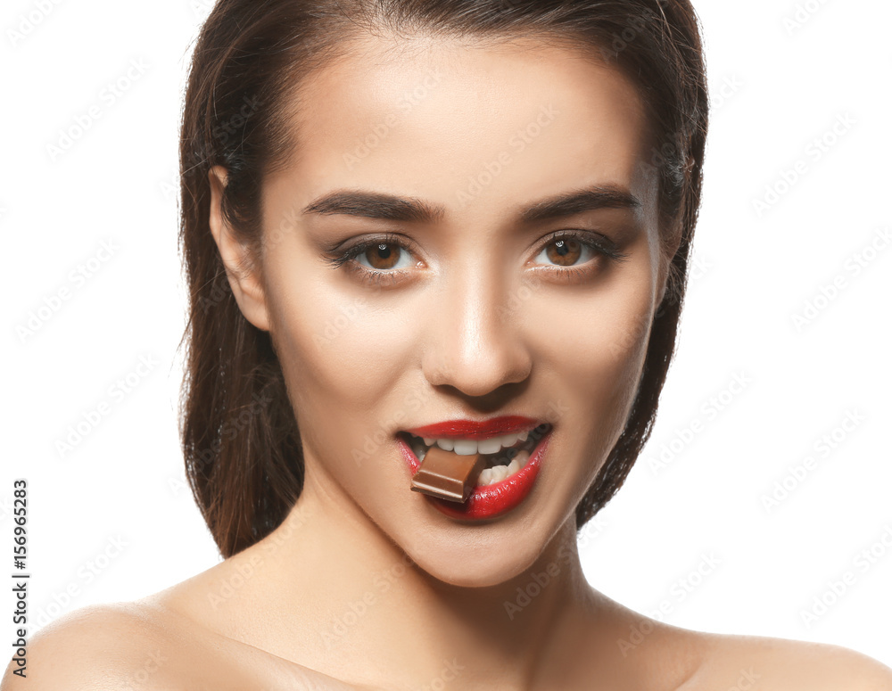 Portrait of beautiful woman with piece of chocolate on white background Portrait of beautiful woman with piece of chocolate on white background