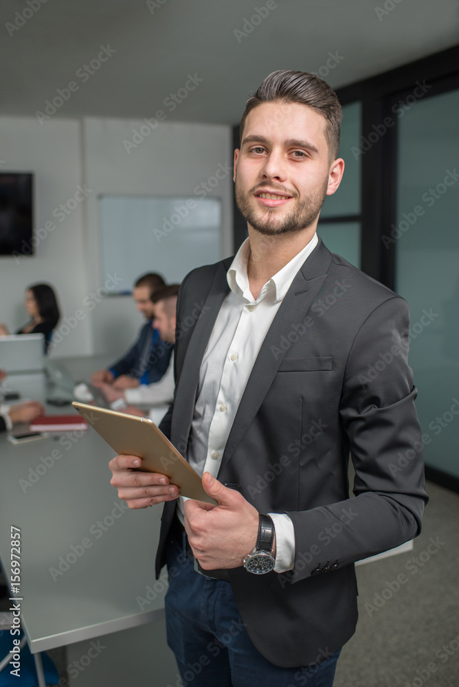 Young business man posing for a camera Young business man posing for a camera