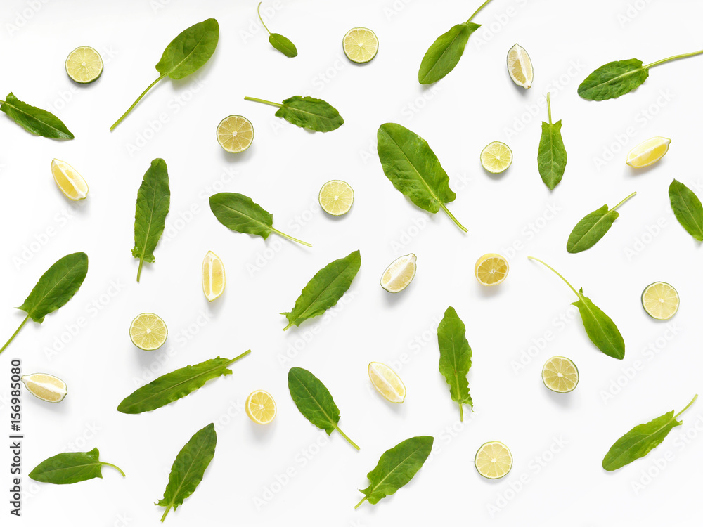 Pattern of citrus. Sorrel, slices of lemon and lime isolated on white background. Abstract food background. Pattern of citrus. Sorrel, slices of lemon and lime isolated on white background. Abstract food background.