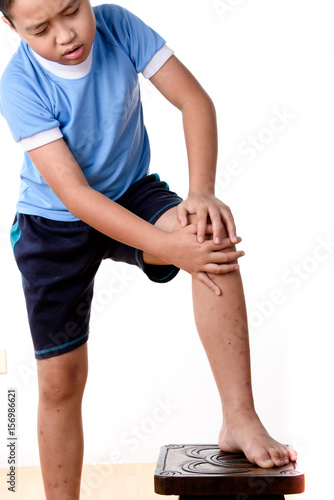 Young asian boy has pain at knee