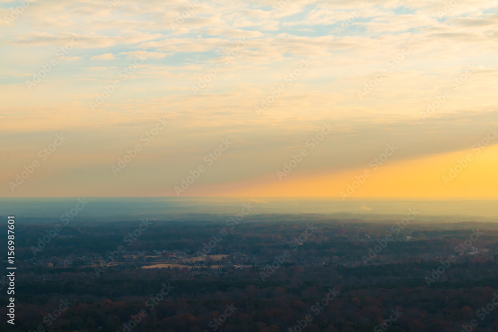 Aerial view of forest and settlements from the top of the Stone Mountain at sunset, Georgia, USA