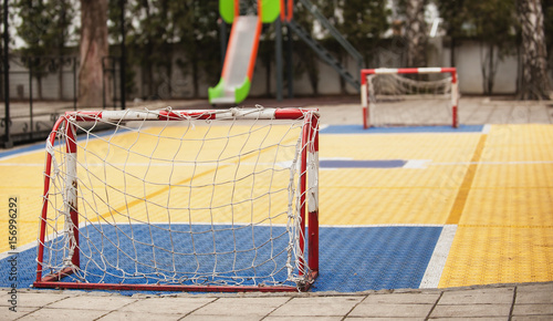 Small soccer field with football goal on children playground yard