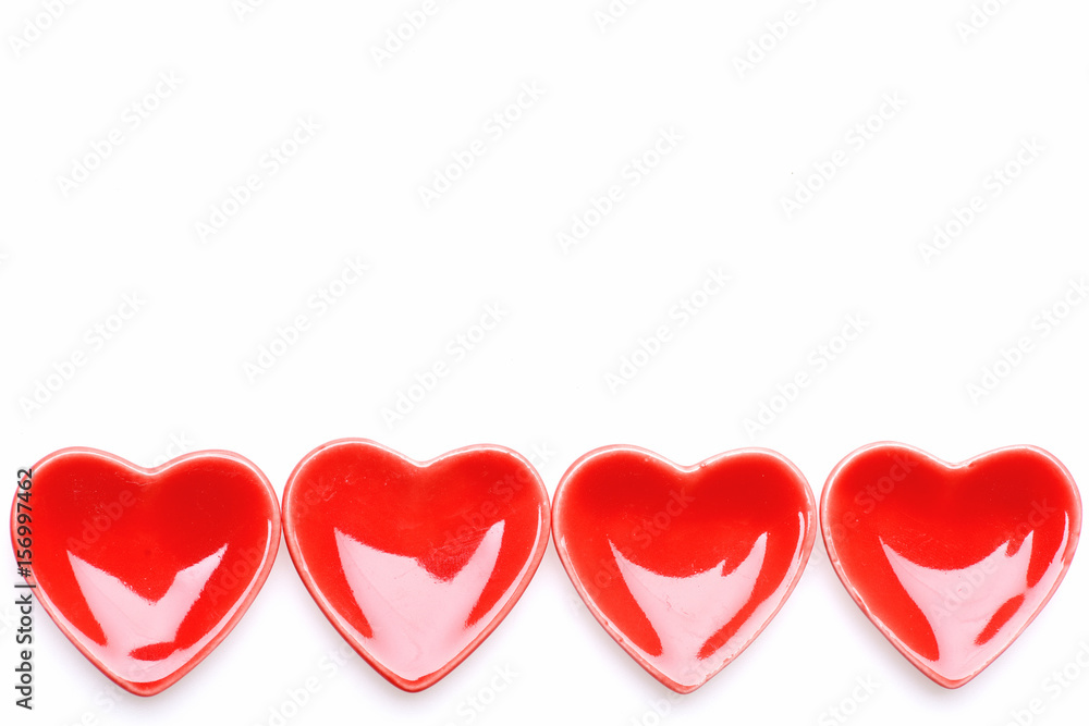 Pattern made of red ceramic heart shaped saucers