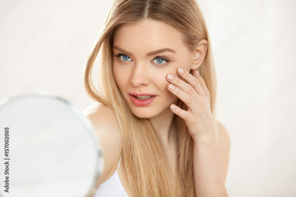 Beautiful Woman With Makeup Touching Skin In Front Of Mirror Beautiful Woman With Makeup Touching Skin In Front Of Mirror