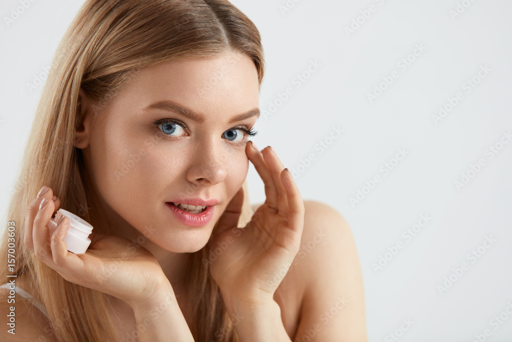Beautiful Woman Applying Cream On Skin Under Eyes