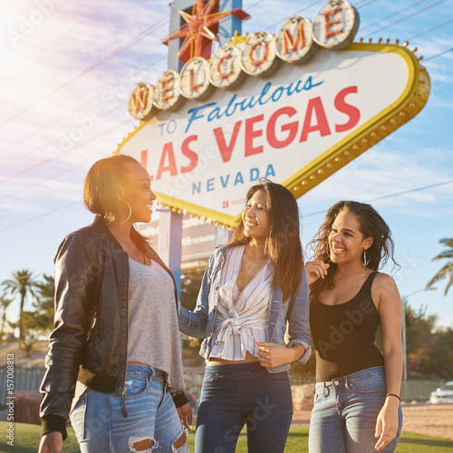 Photography happy all girl group of friends by welcome to las vegas sign