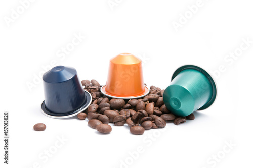 coffee capsules with coffee beans on white background