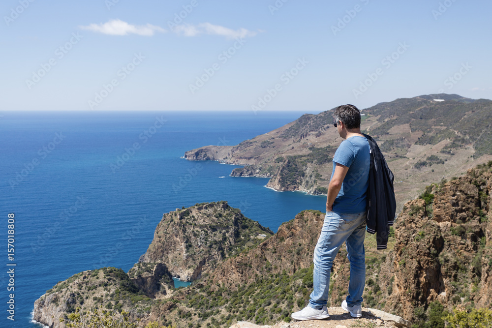 Tourist looking at sea bays in Antiochia ad Cragum