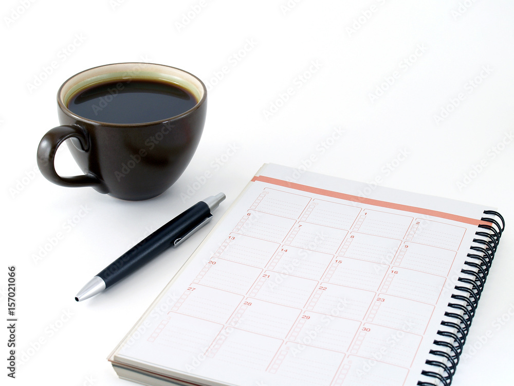 notebook, pen and dark brown ceramic cup of coffee isolated on white background, diary calendar for planning in coffee time notebook, pen and dark brown ceramic cup of coffee isolated on white background, diary calendar for planning in coffee time