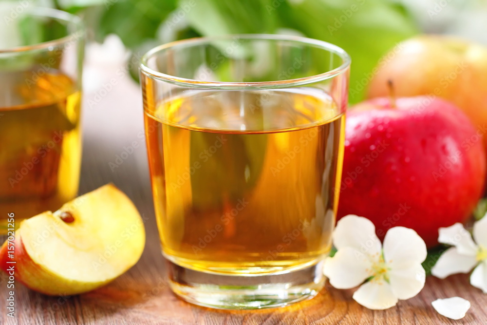 Sweet apple juice, apples and flowers on the table Sweet apple juice, apples and flowers on the table
