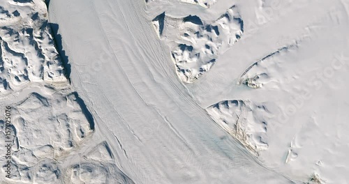 High-altitude overflight aerial of Petermann Glacier on Greenland's northwest coast. Clip loops and is reversible. Elements of this image furnished by USGS/NASA Landsat