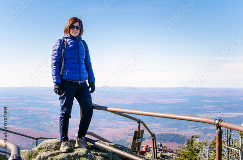 Woman Hiker on the Peak of a Mountain on a Sunny Autumn Day. 
