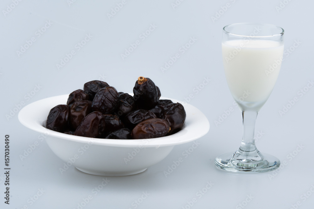 Isolated dates with milk in a plate Isolated dates with milk in a plate