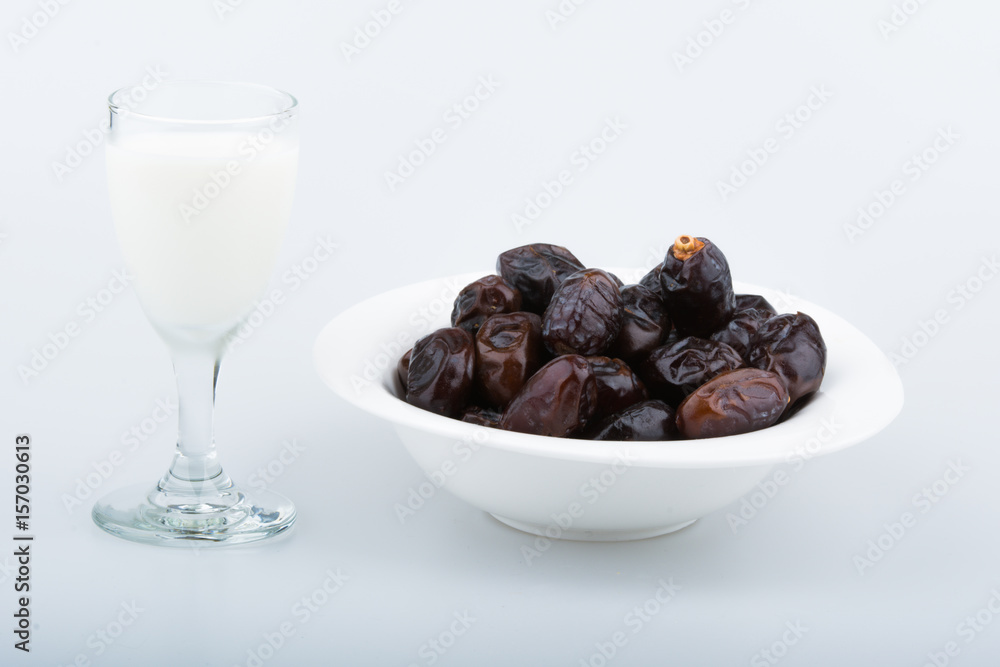 Isolated dates with milk in a plate Isolated dates with milk in a plate