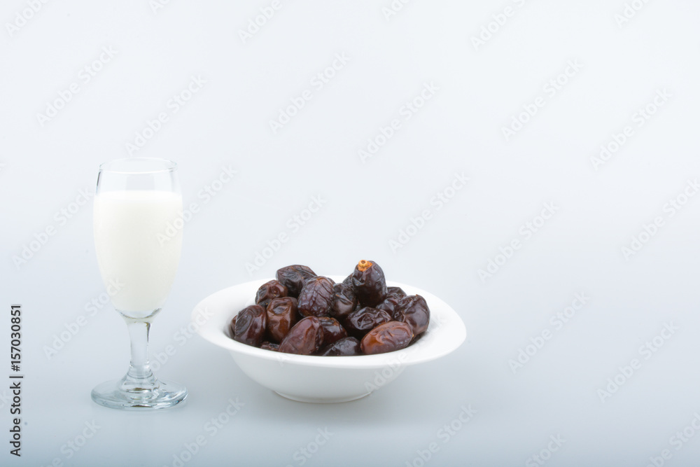 Isolated dates with milk in a plate Isolated dates with milk in a plate
