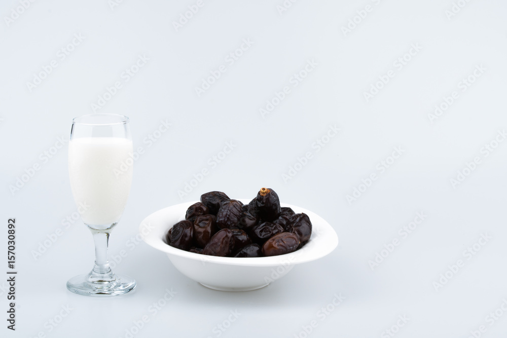 Isolated dates with milk in a plate Isolated dates with milk in a plate