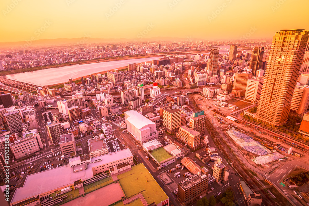 Aerial view of Osaka City Central business and Yodo River with its bridges at sunset colors. Osaka Skyline from Kita ward of Japan.