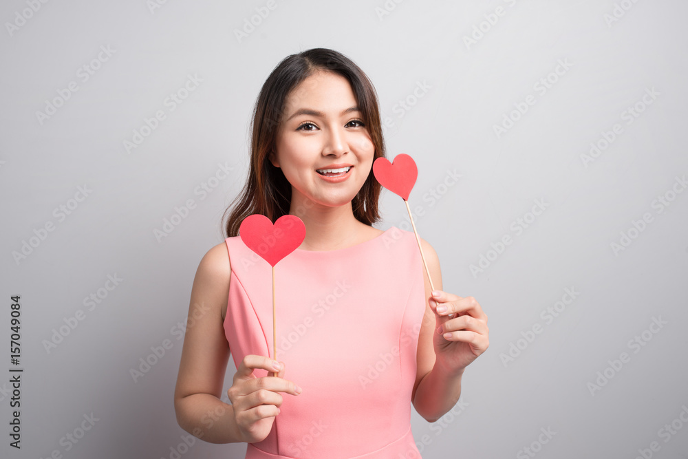 Charming asian woman holding red heart shape. Charming asian woman holding red heart shape.