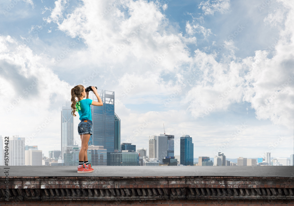 Concept of careless happy childhood with girl of school age looking in future